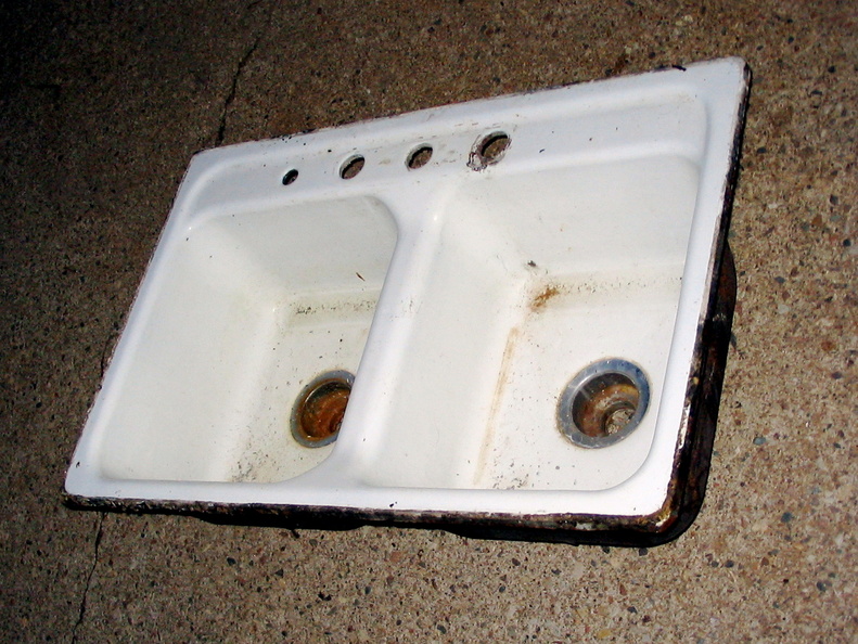 In July '05, I replaced the Newby's kitchen sink. This is the old one after sitting outside for a day or two. The real problem is that it was rusting through by the faucet holes but it was also in generally poor shape and had shallow basins. IMG_3464.jpg
